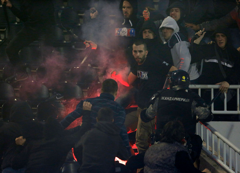 Illustration for article titled Smoke, Flares, Riot Police In Belgrade Derby Make For Haunting Photos